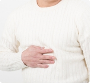 おなかを抑える中年男性